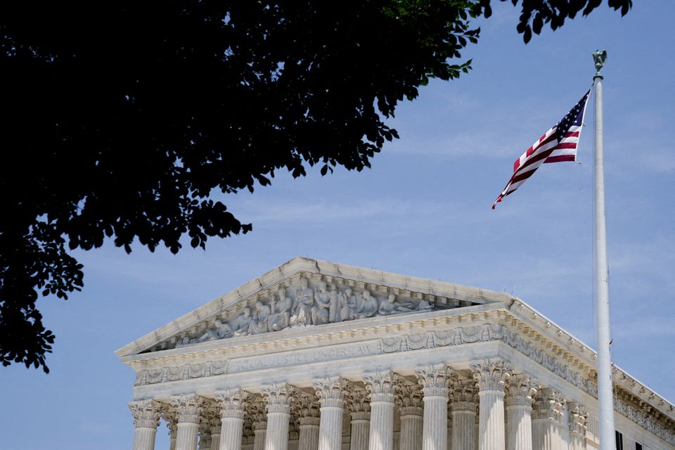 An American flag flys in front of the US Supreme Court building